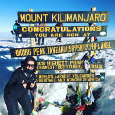 climber at the top of Kilimanjaro